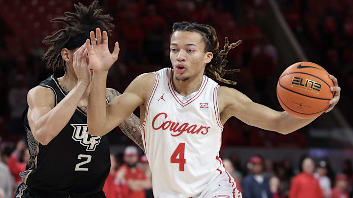 Feb 4, 2026; Houston, Texas, USA; Houston Cougars guard Kingston Flemings (4) drives against UCF Knights guard Riley Kugel (2) in the first half at Fertitta Center. 