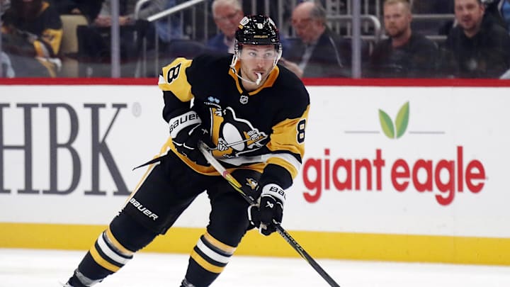 Oct 16, 2024; Pittsburgh, Pennsylvania, USA; Pittsburgh Penguins left wing Michael Bunting (8) skates with the puck against the Buffalo Sabres during the third period at PPG Paints Arena. The Pens won 6-5 in overtime. Mandatory Credit: Charles LeClaire-Imagn Images