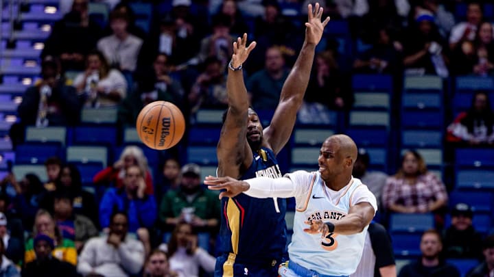 Feb 23, 2025; New Orleans, Louisiana, USA;  San Antonio Spurs guard Chris Paul (3) passes the ball against New Orleans Pelicans forward Zion Williamson (1) during the first half at Smoothie King Center. Mandatory Credit: Stephen Lew-Imagn Images