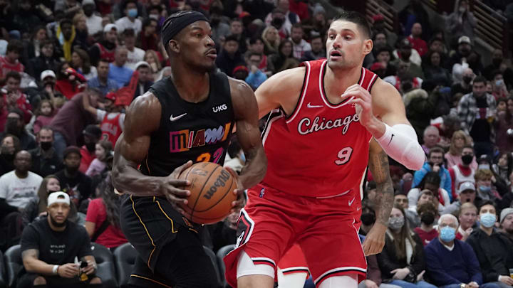 Nov 27, 2021; Chicago, Illinois, USA; Miami Heat forward Jimmy Butler (22) is defended by Chicago Bulls center Nikola Vucevic (9) during the second half at United Center. Mandatory Credit: David Banks-Imagn Images