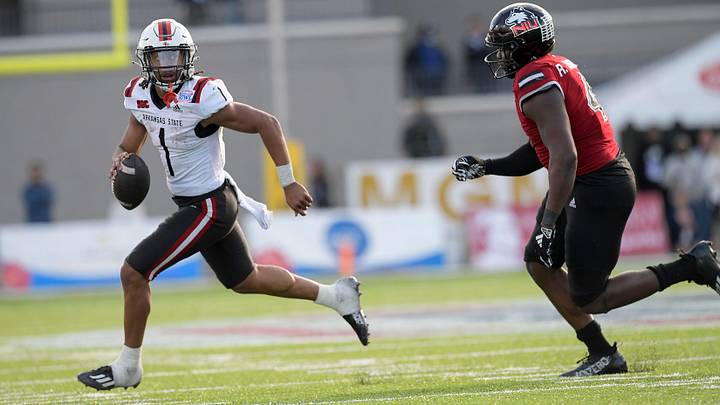 Arkansas State Red Wolves quarterback Jaylen Raynor (1) is pursued by Northern Illinois Huskies defensive end Raishein Thomas (4) in second half action in the Camellia Bowl at Cramton Bowl in Montgomery, Ala., on Saturday December 23, 2023. Arkansas State Red Wolves quarterback Jaylen Raynor (1) is pursued by Northern Illinois Huskies defensive end Raishein Thomas (4) in second half action in the Camellia Bowl at Cramton Bowl in Montgomery, Ala., on Saturday December 23, 2023.