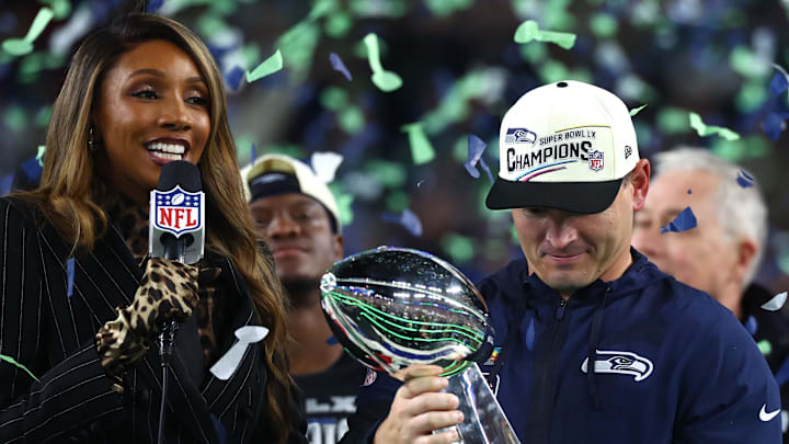 Feb 8, 2026; Santa Clara, CA, USA; Seattle Seahawks head coach Mike MacDonald celebrates with the Vince Lombardi trophy on the podium after defeating the New England Patriots in Super Bowl LX at Levi's Stadium. Mandatory Credit: Mark J. Rebilas-Imagn Images