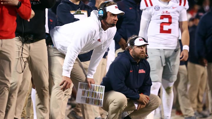 Nov 23, 2023; Starkville, Mississippi, USA; Mississippi Rebels head coach Lane Kiffin (left) and Mississippi Rebels defensive coordinator Pete Golding (right) watch during the second half against the Mississippi State Bulldogs at Davis Wade Stadium at Scott Field. Mandatory Credit: Petre Thomas-Imagn Images Nov 23, 2023; Starkville, Mississippi, USA; Mississippi Rebels head coach Lane Kiffin (left) and Mississippi Rebels defensive coordinator Pete Golding (right) watch during the second half against the Mississippi State Bulldogs at Davis Wade Stadium at Scott Field. Mandatory Credit: Petre Thomas-Imagn Images