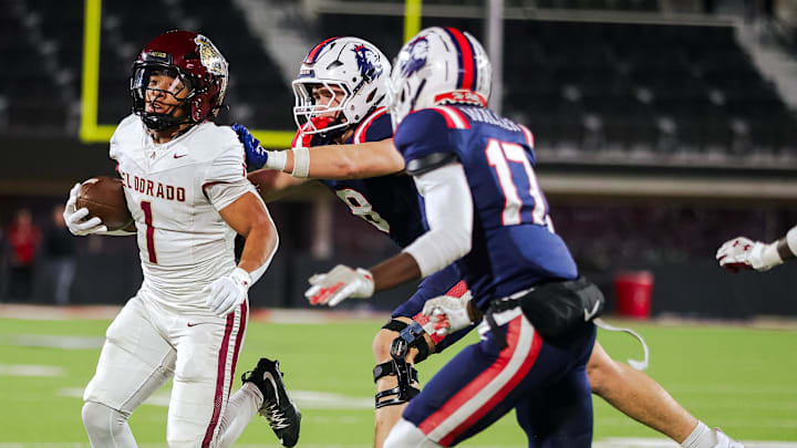 El Dorado’s Ryan Estrada carries the ball against Richland’s Gage Goodwin pushes Estrada out of bounds in a 5A D1 playoff game, Nov. 21, 2025, at the Jones AT&T Stadium in Lubbock.