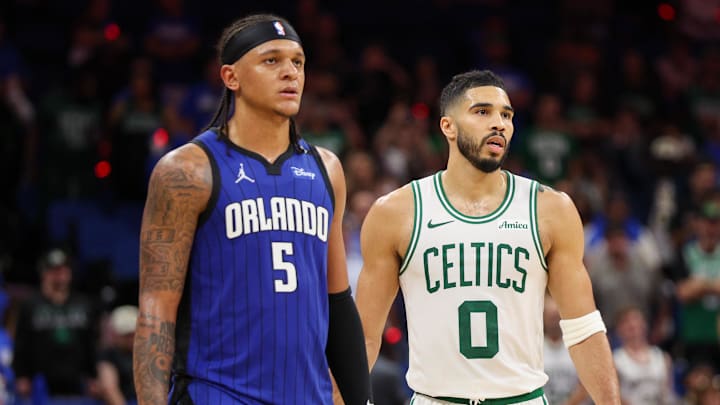 Orlando Magic forward Paolo Banchero (5) and Boston Celtics forward Jayson Tatum (0) wait for a break in play in the fourth quarter during game four of first round for the 2025 NBA Playoffs at Kia Center.