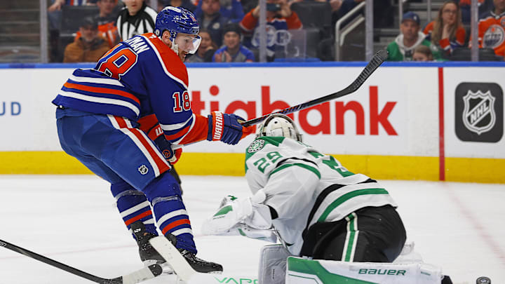 Mar 26, 2025; Edmonton, Alberta, CAN; Dallas Stars goaltender Jake Oettinger (29) makes a save on  on Edmonton Oilers forward Zach Hyman (18) during the third period at Rogers Place. Mandatory Credit: Perry Nelson-Imagn Images