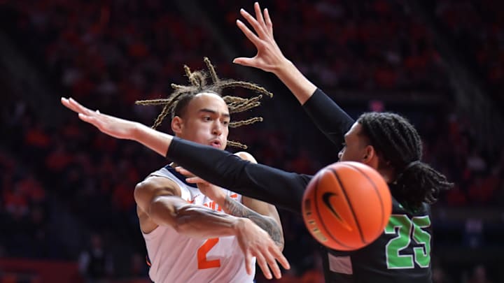 Dec 29, 2024; Champaign, Illinois, USA;  Illinois Fighting Illini guard Dra Gibbs-Lawhorn (2) passes the ball past Chicago State Cougars forward Mike Brown (25) during the first half at State Farm Center. Mandatory Credit: Ron Johnson-Imagn Images