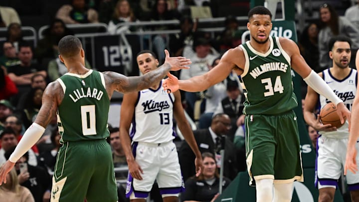 Jan 14, 2025; Milwaukee, Wisconsin, USA; Milwaukee Bucks forward Giannis Antetokounmpo (34) reacts with guard Damian Lillard (0) after scoring a basket in the second quarter against the Sacramento Kings at Fiserv Forum. Mandatory Credit: Benny Sieu-Imagn Images