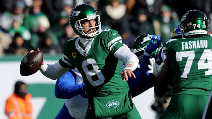 Dec 22, 2024; East Rutherford, New Jersey, USA; New York Jets quarterback Aaron Rodgers (8) drops back to pass against the Los Angeles Rams during the first quarter at MetLife Stadium. 