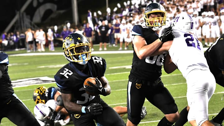 Greylo Coach (32) heads in for a Moeller touchdown against Elder at Nippert Stadium on Oct. 4, 2024.