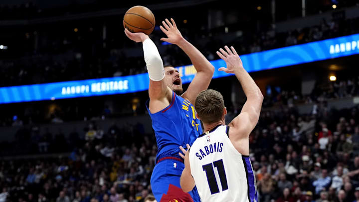 Jan 23, 2025; Denver, Colorado, USA; Denver Nuggets center Nikola Jokic (15) shoots over Sacramento Kings forward Domantas Sabonis (11) in the first quarter at Ball Arena. Mandatory Credit: Ron Chenoy-Imagn Images