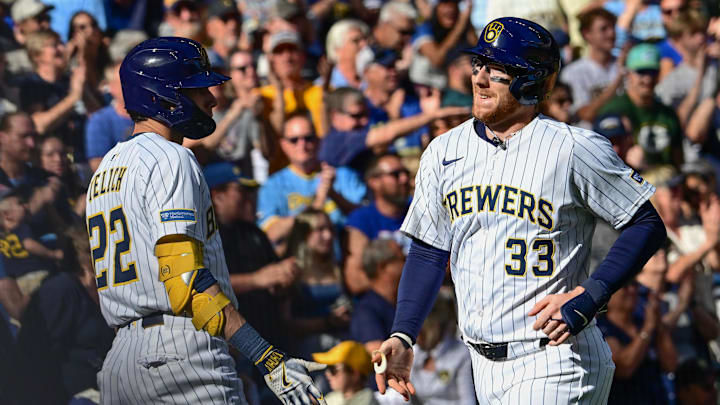 Sep 28, 2025; Milwaukee, Wisconsin, USA; Milwaukee Brewers catcher Danny Jansen (33) is greeted by  designated hitter Christian Yelich (22) after hitting a 2-run homer in the fourth inning against the Cincinnati Reds at American Family Field. Mandatory Credit: Benny Sieu-Imagn Images