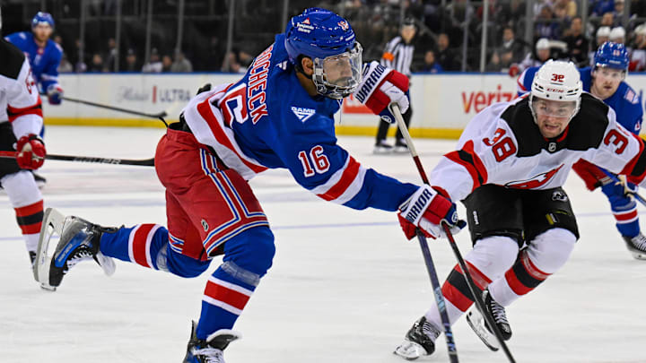 Oct 2, 2025; New York, New York, USA;  New York Rangers center Vincent Trocheck (16) attempts a shot defended by New Jersey Devils defenseman Topias Vilen (38) during the second period at Madison Square Garden. Mandatory Credit: Dennis Schneidler-Imagn Images