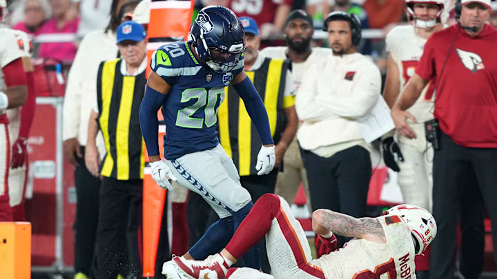 Sep 25, 2025; Glendale, Arizona, USA; Seattle Seahawks safety Julian Love (20) reacts after a tackling Arizona Cardinals tight end Trey McBride (85) in the second quarter at State Farm Stadium. Mandatory Credit: Joe Camporeale-Imagn Images