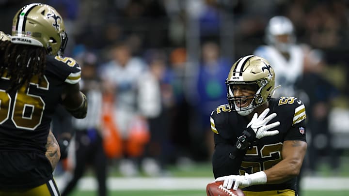 Saints linebackers Demario Davis and D'Marco Jackson celebrate a touchdown versus the Carolina Panthers on Dec. 10, 2023.