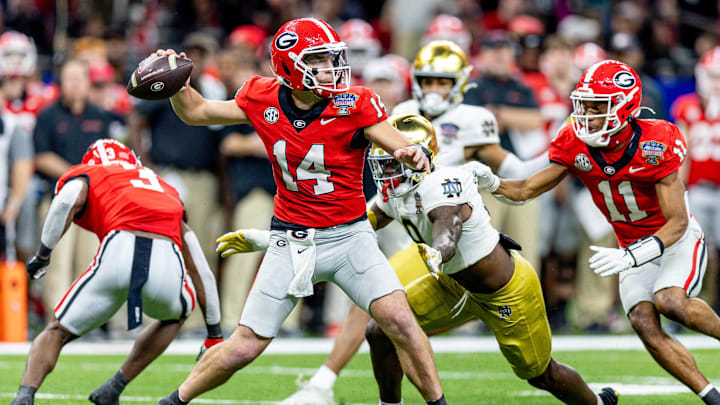 Jan 2, 2025; New Orleans, LA, USA; Georgia Bulldogs quarterback Gunner Stockton (14) passes against Notre Dame Fighting Irish defensive lineman RJ Oben (9) during the second half at Caesars Superdome. Mandatory Credit: Stephen Lew-Imagn Images Jan 2, 2025; New Orleans, LA, USA; Georgia Bulldogs quarterback Gunner Stockton (14) passes against Notre Dame Fighting Irish defensive lineman RJ Oben (9) during the second half at Caesars Superdome. Mandatory Credit: Stephen Lew-Imagn Images