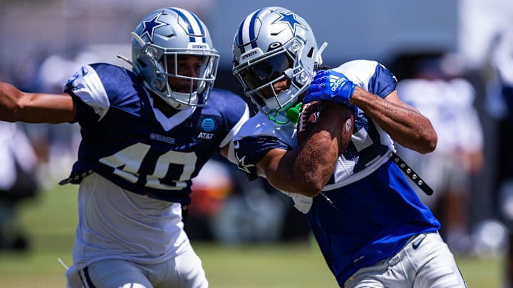 Dallas Cowboys wide receiver Jalen Tolbert keeps the ball from safety Juanyeh Thomas during training camp.