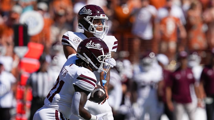 Sep 28, 2024; Austin, Texas, USA;  Mississippi State Bulldogs running back Davon Booth (21) takes a handoff from quarterback Michael Van Buren Jr. (0) in the first half against the Texas Longhorns at Darrell K Royal-Texas Memorial Stadium. Mandatory Credit: Daniel Dunn-Imagn Images