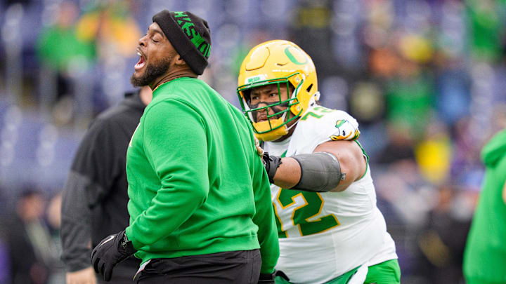 Oregon offensive line coach A'lique Terry and offensive lineman Iapani Laloulu led a unit that has closed in on three of college football's most prestigious awards, one group and two individual.