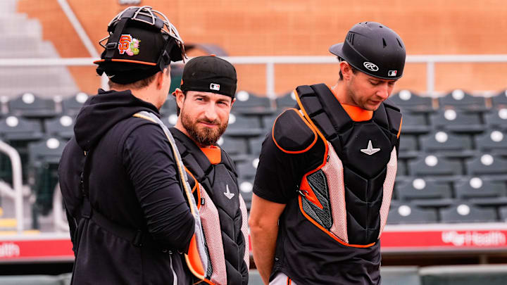 Feb 16, 2026; Scottsdale, AZ, USA; San Francisco Giants catchers Eric Haase (center) and Daniel Susac (right) during workouts at Scottsdale Stadium in Scottsdale, Arizona.  Mandatory Credit: Arianna Grainey-Imagn Images