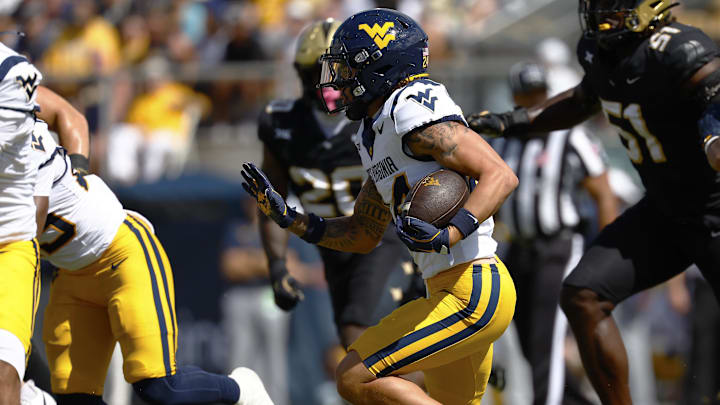 Oct 18, 2025; Orlando, Florida, USA; West Virginia Mountaineers wide receiver Rodney Gallagher III (24) rushes the ball in the first half against the Central Florida Knights at Acrisure Bounce House. Mandatory Credit: Russell Lansford-Imagn Images Oct 18, 2025; Orlando, Florida, USA; West Virginia Mountaineers wide receiver Rodney Gallagher III (24) rushes the ball in the first half against the Central Florida Knights at Acrisure Bounce House. Mandatory Credit: Russell Lansford-Imagn Images
