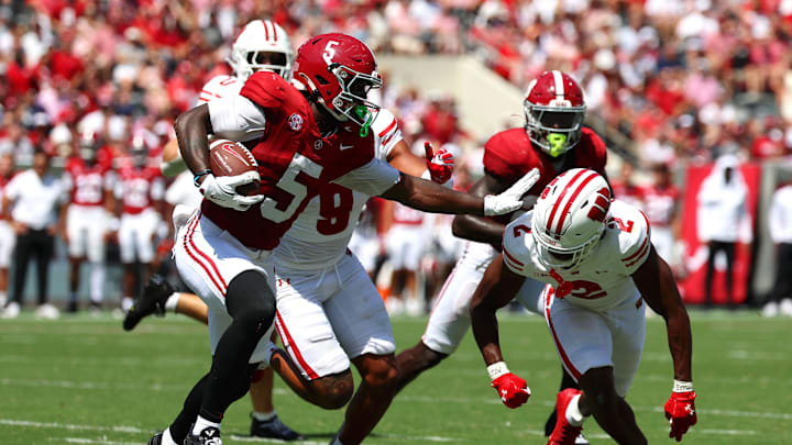 Sep 13, 2025; Tuscaloosa, Alabama, USA; Alabama Crimson Tide wide receiver Germie Bernard (5) avoids a tackle by Wisconsin Badgers cornerback Ricardo Hallman (2) during the second quarter at Saban Field at Bryant-Denny Stadium. Mandatory Credit: David Leong-Imagn Images
