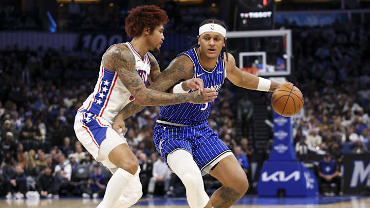 Jan 9, 2026; Orlando, Florida, USA; Orlando Magic forward Paolo Banchero (5) is guarded by Philadelphia 76ers guard Kelly Oubre Jr. (9) in the fourth quarter at Kia Center. Mandatory Credit: Nathan Ray Seebeck-Imagn Images Jan 9, 2026; Orlando, Florida, USA; Orlando Magic forward Paolo Banchero (5) is guarded by Philadelphia 76ers guard Kelly Oubre Jr. (9) in the fourth quarter at Kia Center. Mandatory Credit: Nathan Ray Seebeck-Imagn Images