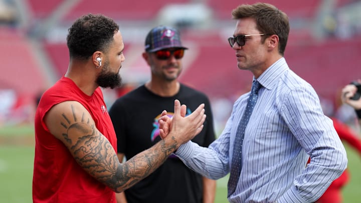 Fox NFL broadcaster and former NFL quarterback Tom Brady speaks to Tampa Bay Buccaneers wide receiver Mike Evans.