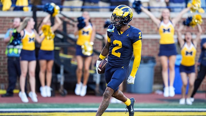 Michigan defensive back Will Johnson (2) celebrates a touchdown after intercepting USC quarterback Miller Moss (7) during the second half at Michigan Stadium in Ann Arbor on Saturday, Sept. 21, 2024.