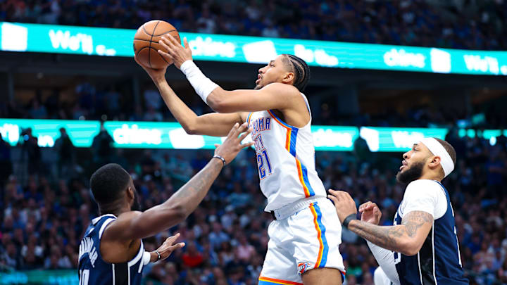 May 11, 2024; Dallas, Texas, USA; Oklahoma City Thunder guard Aaron Wiggins (21) shoots as Dallas Mavericks center Daniel Gafford (21) and Dallas Mavericks forward Tim Hardaway Jr. (10) defend during the second half during game three of the second round for the 2024 NBA playoffs at American Airlines Center. Mandatory Credit: Kevin Jairaj-Imagn Images