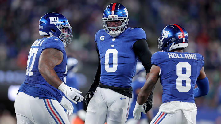 Oct 9, 2025; East Rutherford, New Jersey, USA; New York Giants linebacker Brian Burns (0) celebrates his sack of Philadelphia Eagles quarterback Jalen Hurts (not pictured) with defensive tackle Dexter Lawrence (97) and safety Jevon Holland (8) during the first quarter at MetLife Stadium. 