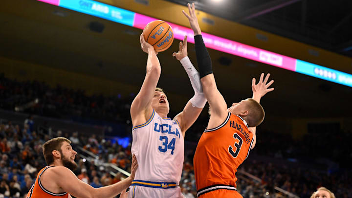 Feb 21, 2026; Los Angeles, California, USA; UCLA forward Tyler Bilodeau (34) tries to score between Illinois forward Ben Humrichous (3) and Illinois center Tomislav Ivisic (13) during the first half at Pauley Pavilion presented by Wescom Financial. Mandatory Credit: Robert Hanashiro-Imagn Images Feb 21, 2026; Los Angeles, California, USA; UCLA forward Tyler Bilodeau (34) tries to score between Illinois forward Ben Humrichous (3) and Illinois center Tomislav Ivisic (13) during the first half at Pauley Pavilion presented by Wescom Financial. Mandatory Credit: Robert Hanashiro-Imagn Images