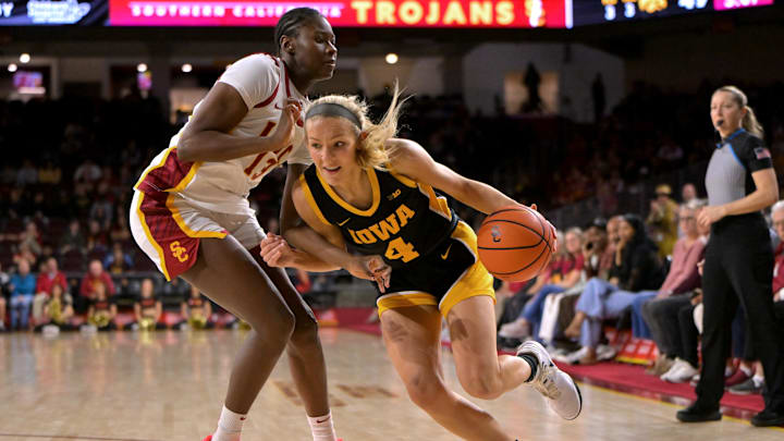 Jan 29, 2026; Los Angeles, California, USA;  USC Trojans forward Dayana Mendes (13) defends Iowa Hawkeyes guard Kylie Feuerbach (4) she drives to the basket in the second half at Galen Center. Mandatory Credit: Jayne Kamin-Oncea-Imagn Images