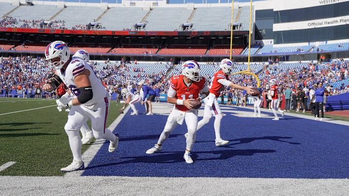 Buffalo Bills QBs Mitchell Trubisky and Mike White turn and make a handoff during the Return of the Blue & Red practice. Buffalo Bills QBs Mitchell Trubisky and Mike White turn and make a handoff during the Return of the Blue & Red practice.