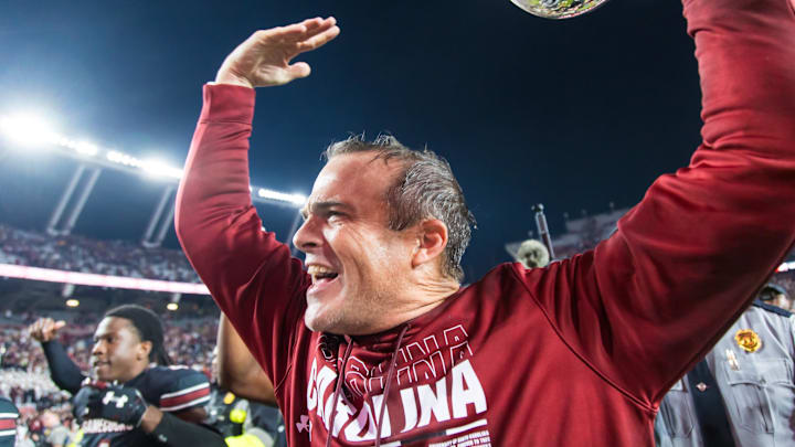 Nov 16, 2024; Columbia, South Carolina, USA; South Carolina Gamecocks head coach Shane Beamer celebrates beating the Missouri Tigers at Williams-Brice Stadium. He is holding the Mayors Cup, given to the winner of the South Carolina-Missouri game. Mandatory Credit: Jeff Blake-Imagn Images