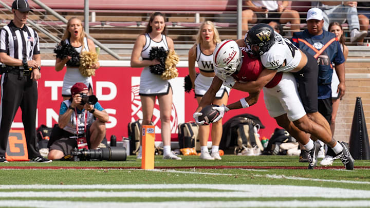 Oct 26, 2024; Stanford, California, USA;  Wake Forest Demon Deacons defensive back Nick Andersen (45) tackles Stanford Cardinal wide receiver Elic Ayomanor (13) during the second quarterat Stanford Stadium. Mandatory Credit: Neville E. Guard-Imagn Images