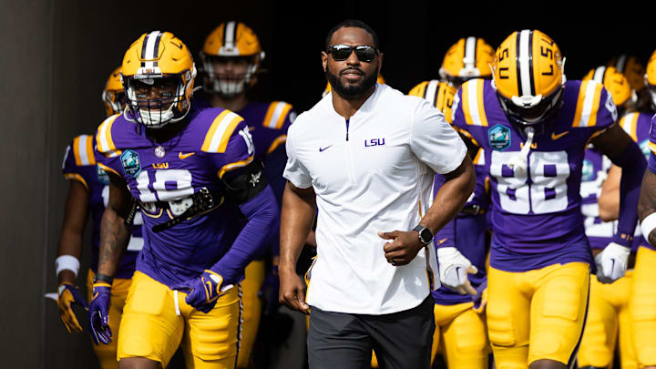 Jan 1, 2024; Tampa, FL, USA; LSU Tigers wide receivers coach Cortez Hankton, tight end Ka'Morreun Pimpton (88), and wide receiver Aaron Anderson (1) run onto the field before the game against the Wisconsin Badgers at Raymond James Stadium. Mandatory Credit: Matt Pendleton-Imagn Images Jan 1, 2024; Tampa, FL, USA; LSU Tigers wide receivers coach Cortez Hankton, tight end Ka'Morreun Pimpton (88), and wide receiver Aaron Anderson (1) run onto the field before the game against the Wisconsin Badgers at Raymond James Stadium. Mandatory Credit: Matt Pendleton-Imagn Images