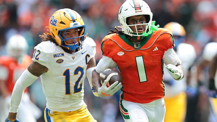 Oct 24, 2026; Miami Gardens, Florida, USA; Miami Hurricanes wide receiver Malachi Toney (1) runs with the football against Pittsburgh Panthers defensive back Cruce Brookins (12) during the second quarter at Hard Rock Stadium. Mandatory Credit: Sam Navarro-Imagn Images Oct 24, 2026; Miami Gardens, Florida, USA; Miami Hurricanes wide receiver Malachi Toney (1) runs with the football against Pittsburgh Panthers defensive back Cruce Brookins (12) during the second quarter at Hard Rock Stadium. Mandatory Credit: Sam Navarro-Imagn Images