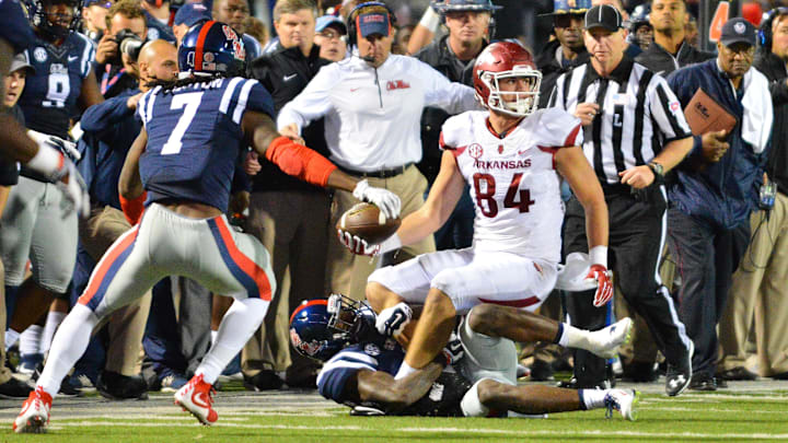 Nov 7, 2015; Oxford, MS, USA; Arkansas Razorbacks tight end Hunter Henry (84) laterals the ball as he is tackled by Mississippi Rebels defensive back Tony Bridges (1) during overtime at Vaught-Hemingway Stadium. Arkansas won 53-52. Mandatory Credit: Matt Bush-USA TODAY Sports