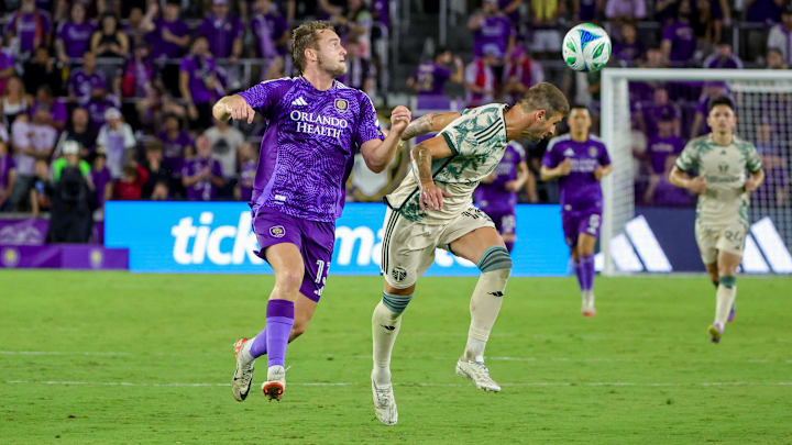 May 24, 2025; Orlando, Florida, USA; Portland Timbers defender Dario Župaric (13) heads the ball in front of Orlando City forward Duncan McGuire (13) during the second half at Inter&Co Stadium. Mandatory Credit: Mike Watters-Imagn Images