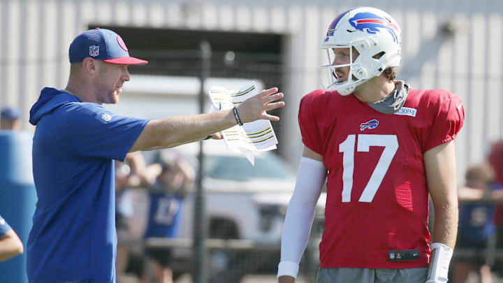 Bills quarterback Josh Allen talks with offensive coordinator Joe Brady.