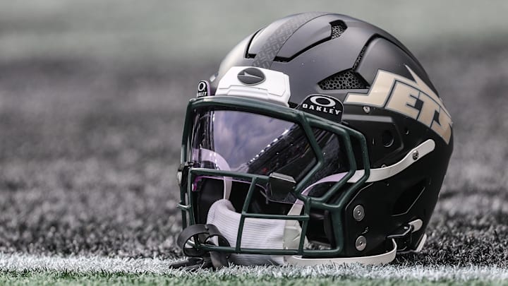 Dec 7, 2025; East Rutherford, New Jersey, USA; A general view of a Gotham City football rivalries helmet resting on the field before the game against the Miami Dolphins at MetLife Stadium. Mandatory Credit: Vincent Carchietta-Imagn Images