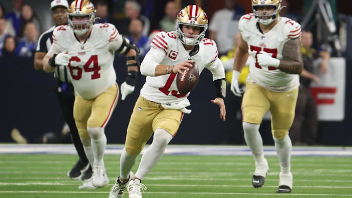 Dec 22, 2025; Indianapolis, Indiana, USA; San Francisco 49ers quarterback Brock Purdy (13) scrambles with the ball against the Indianapolis Colts in the second quarter of the game at Lucas Oil Stadium. Mandatory Credit: Trevor Ruszkowski-Imagn Images