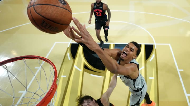 Dec 16, 2025; Las Vegas, Nevada, USA; San Antonio Spurs forward Victor Wembanyama (1) dunks the ball past New York Knicks guard Tyler Kolek (13) in the second half during the Emirates NBA Cup Final at T-Mobile Arena. Mandatory Credit: Kirby Lee-Imagn Images
