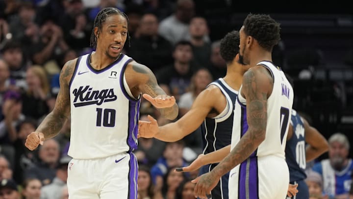 Dec 30, 2024; Sacramento, California, USA; Sacramento Kings forward DeMar DeRozan (10) talks with guard Malik Monk (right) during the second quarter against the Dallas Mavericks at Golden 1 Center. Mandatory Credit: Darren Yamashita-Imagn Images