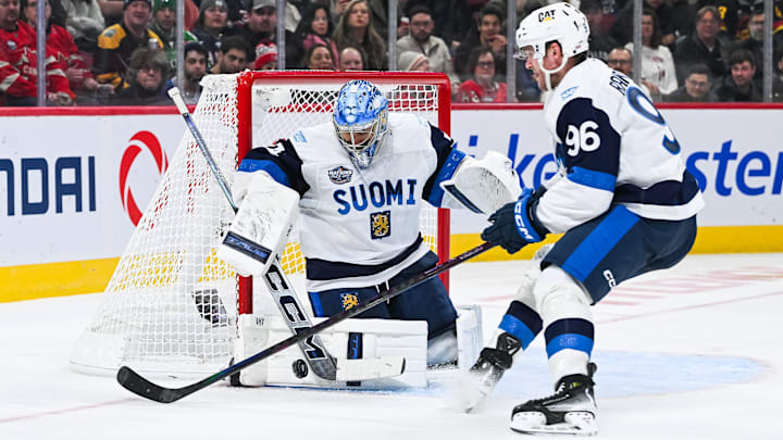 Feb 13, 2025; Montreal, Quebec, CAN; [Imagn Images direct customers only] Team Finland goalie Juuse Saros (74) makes a save near forward Mikko Rantanen (96) against Team USA in the third period during a 4 Nations Face-Off ice hockey game at Bell Centre. Mandatory Credit: David Kirouac-Imagn Images