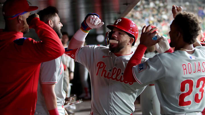 May 24, 2025; West Sacramento, California, USA; Philadelphia Phillies designated hitter Kyle Schwarber (12) is congratulated by teammates in the dugout after hitting a solo home run against the Athletics during the sixth inning at Sutter Health Park.