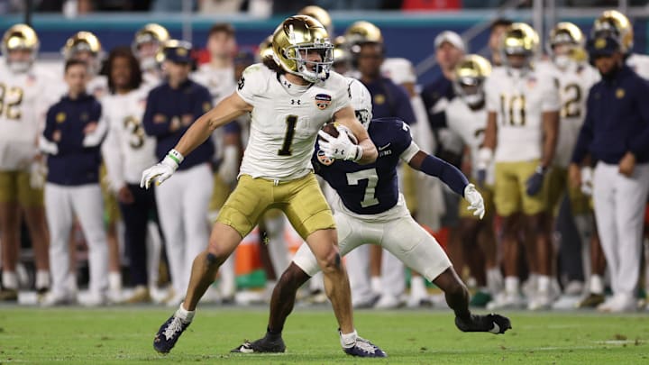Jan 9, 2025; Miami, FL, USA; Notre Dame Fighting Irish wide receiver Jaden Greathouse (1) runs the ball in the second half against the Penn State Nittany Lions in the Orange Bowl at Hard Rock Stadium. Mandatory Credit: Nathan Ray Seebeck-Imagn Images Jan 9, 2025; Miami, FL, USA; Notre Dame Fighting Irish wide receiver Jaden Greathouse (1) runs the ball in the second half against the Penn State Nittany Lions in the Orange Bowl at Hard Rock Stadium. Mandatory Credit: Nathan Ray Seebeck-Imagn Images