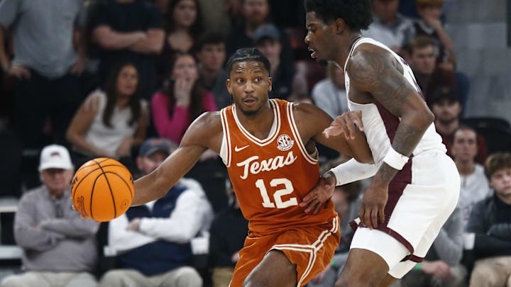 Mar 4, 2025; Starkville, Mississippi, USA; Texas Longhorns guard Tramon Mark (12) dribbles as Mississippi State Bulldogs forward Cameron Matthews (4) defends during the second half at Humphrey Coliseum. Mandatory Credit: Petre Thomas-Imagn Images