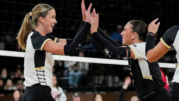 Purdue Boilermakers outside hitter Kenna Wollard (4) high-fives defensive specialist Ryan McAleer. Purdue Boilermakers outside hitter Kenna Wollard (4) high-fives defensive specialist Ryan McAleer.